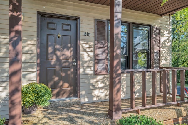 doorway to property featuring covered porch