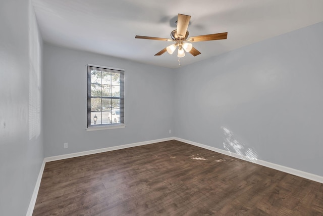 unfurnished room featuring ceiling fan, baseboards, and dark wood finished floors