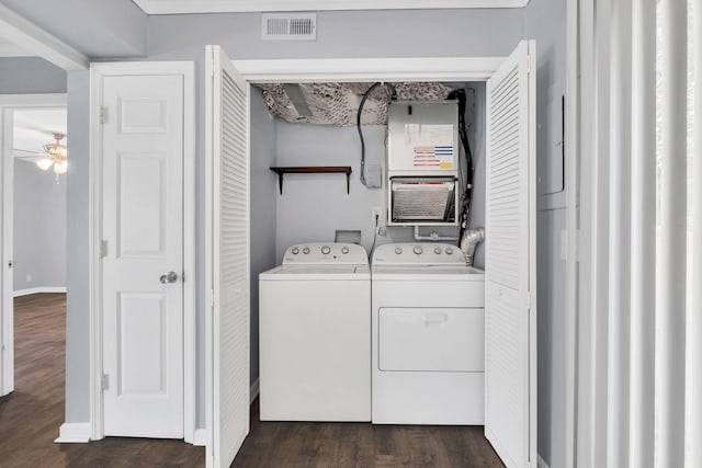 clothes washing area featuring visible vents, dark wood-type flooring, laundry area, independent washer and dryer, and baseboards