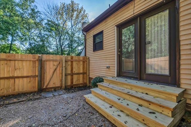 view of exterior entry with fence