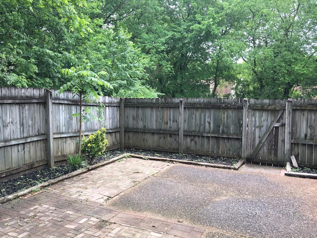 view of patio featuring a fenced backyard and a gate