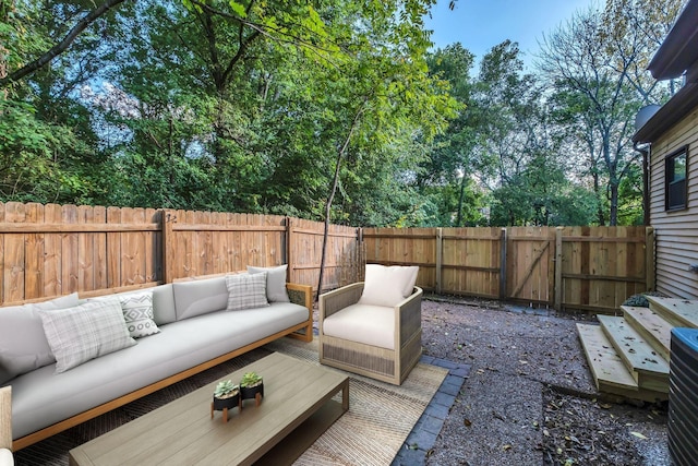 view of patio featuring an outdoor hangout area, a fenced backyard, and a gate