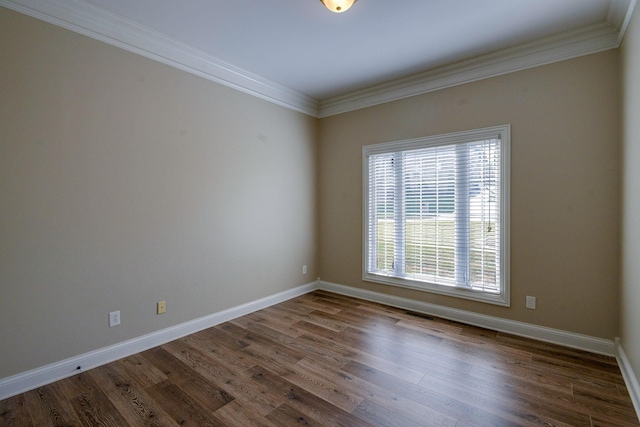 unfurnished room featuring crown molding, dark wood-style flooring, and baseboards