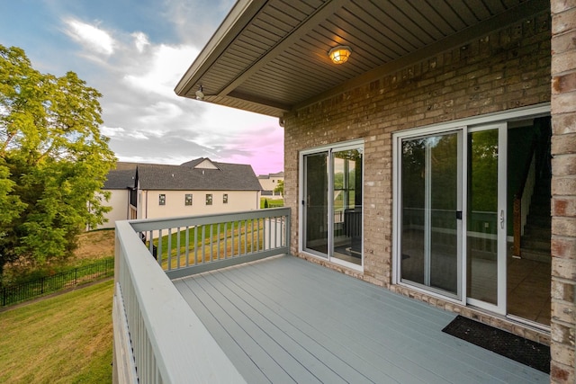 deck featuring fence and a yard