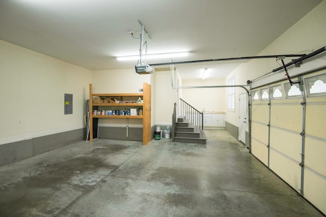 garage with electric panel and a garage door opener