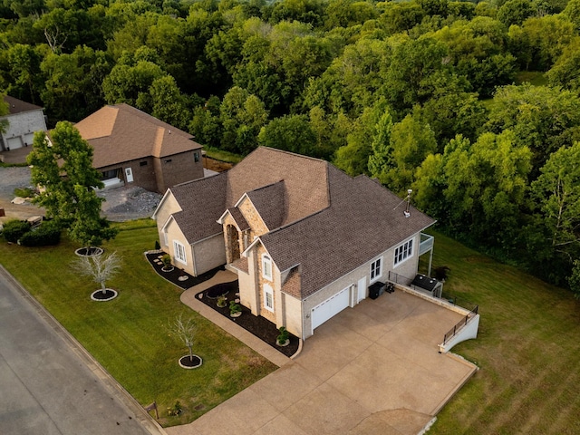 aerial view featuring a wooded view