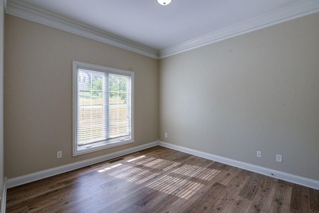 empty room with crown molding, baseboards, and dark wood-style flooring