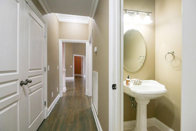 bathroom featuring ornamental molding, wood finished floors, visible vents, and baseboards