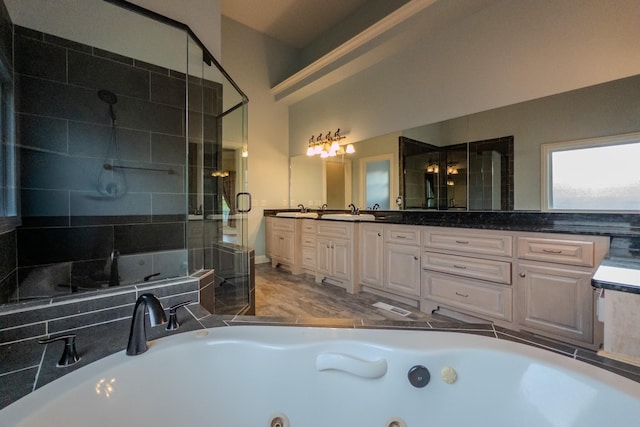 bathroom featuring a stall shower, a sink, and double vanity