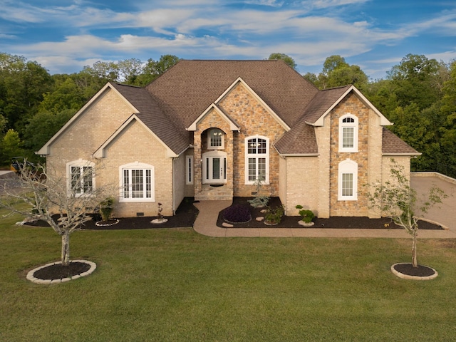 view of front of home with roof with shingles, brick siding, crawl space, and a front yard