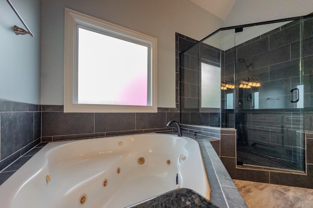 bathroom with a jetted tub and a shower stall