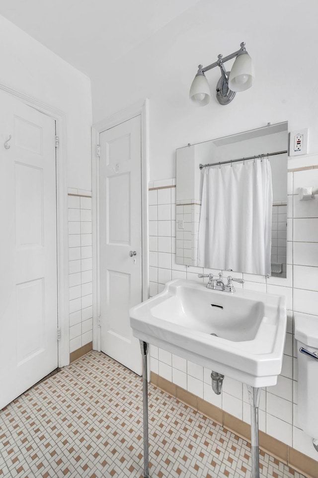 bathroom with tile walls