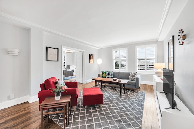 living room with baseboards, wood finished floors, and crown molding