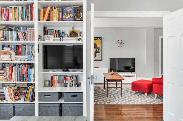 sitting room featuring crown molding and wood finished floors