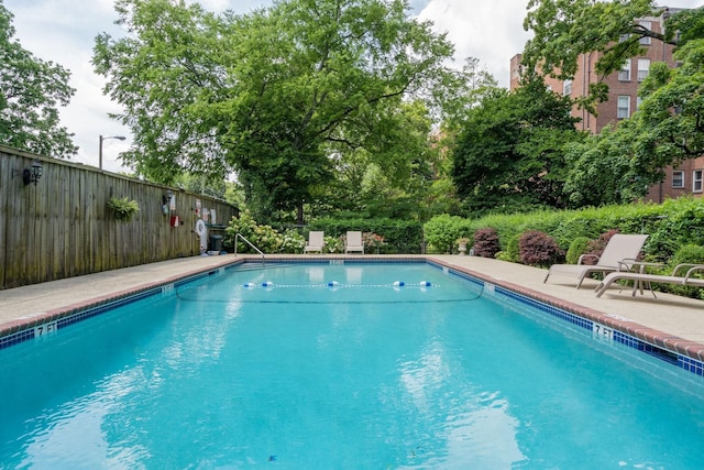 pool with fence and a patio