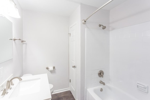 bathroom featuring baseboards, toilet, wood finished floors,  shower combination, and a closet