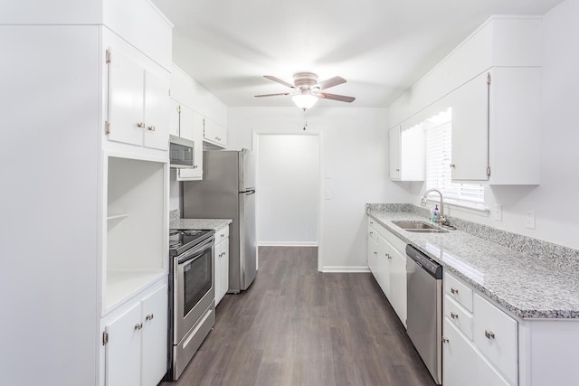 kitchen featuring appliances with stainless steel finishes, a sink, and white cabinets