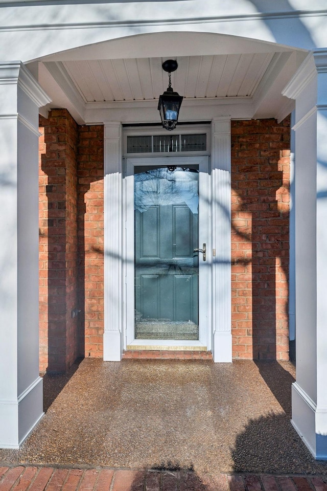 view of exterior entry with brick siding