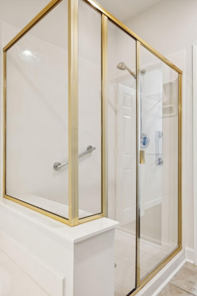 full bath featuring a stall shower and tile patterned floors