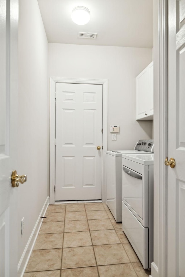 clothes washing area featuring cabinet space, light tile patterned floors, baseboards, visible vents, and independent washer and dryer