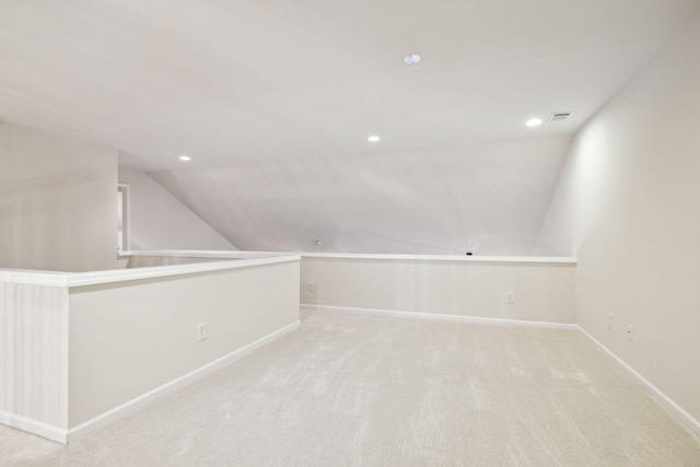 additional living space featuring recessed lighting, visible vents, light carpet, vaulted ceiling, and baseboards