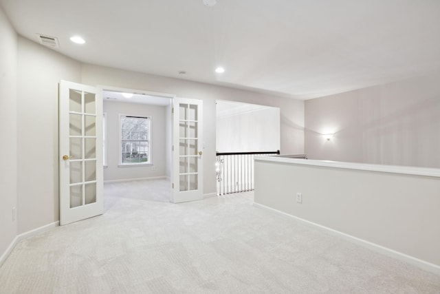 unfurnished room featuring visible vents, baseboards, light colored carpet, french doors, and recessed lighting