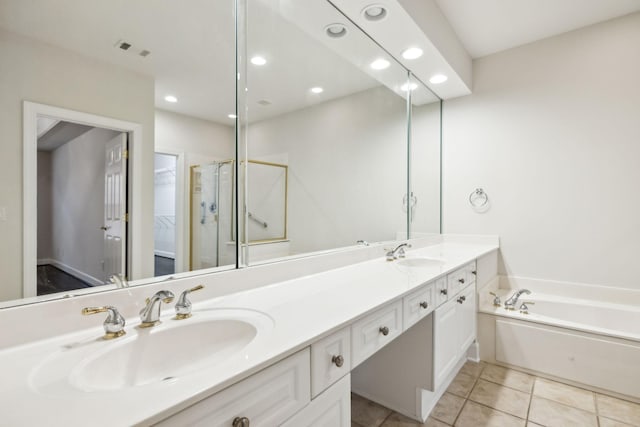 bathroom with tile patterned flooring, a garden tub, a sink, and double vanity