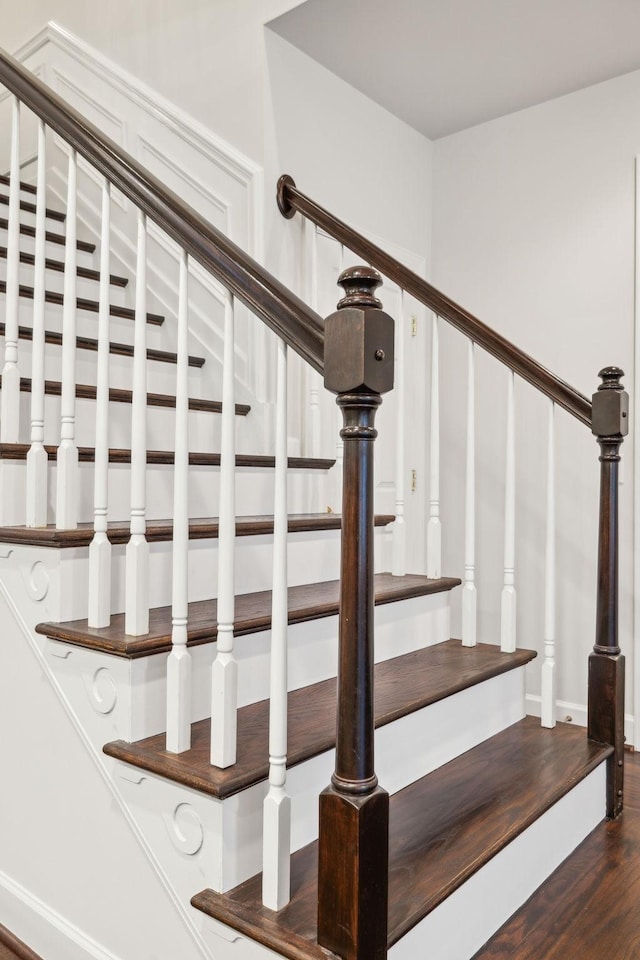 staircase with wood finished floors