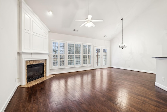 unfurnished living room with ceiling fan with notable chandelier, dark wood-type flooring, a premium fireplace, visible vents, and baseboards