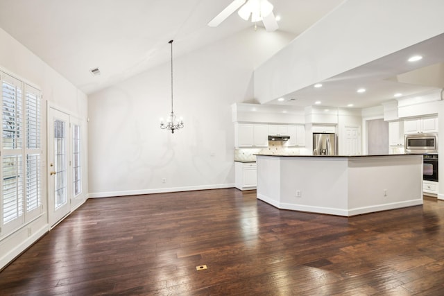 kitchen featuring pendant lighting, a center island with sink, stainless steel appliances, dark wood-type flooring, and white cabinetry