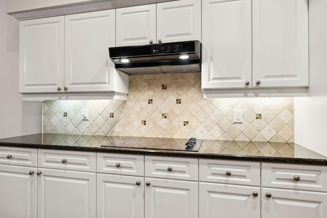 kitchen featuring tasteful backsplash, black electric stovetop, white cabinetry, and under cabinet range hood