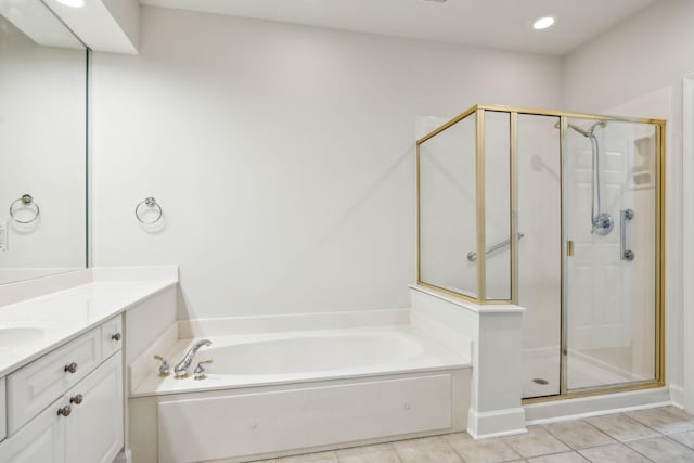 full bath with a garden tub, vanity, a stall shower, and tile patterned floors