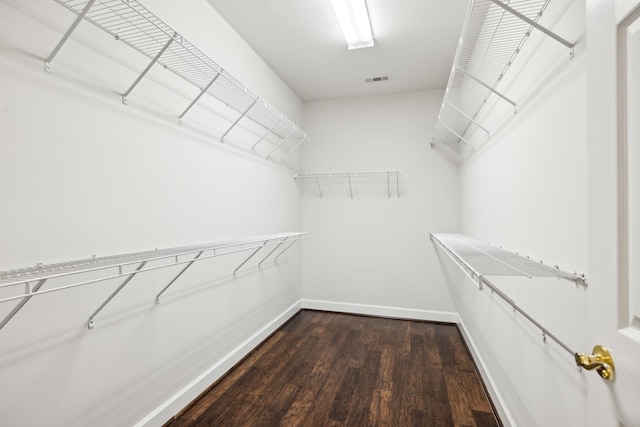 spacious closet featuring dark wood-style floors and visible vents