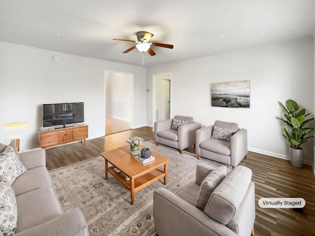 living room with ceiling fan, wood finished floors, and baseboards