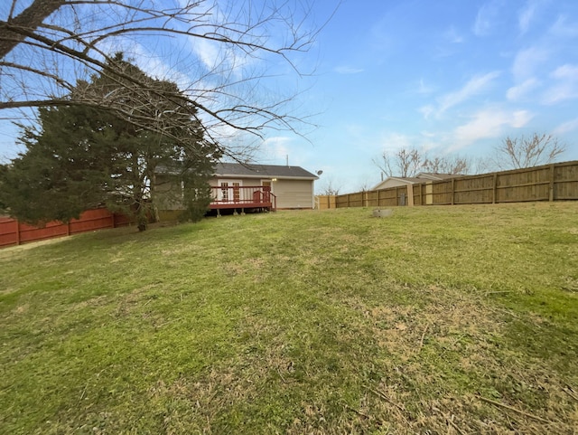 view of yard with a fenced backyard and a wooden deck