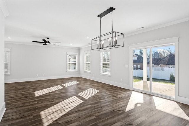 unfurnished dining area featuring a healthy amount of sunlight, visible vents, dark wood-style flooring, and ornamental molding