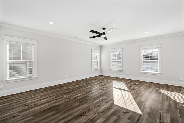 unfurnished room with ornamental molding, dark wood-type flooring, and baseboards