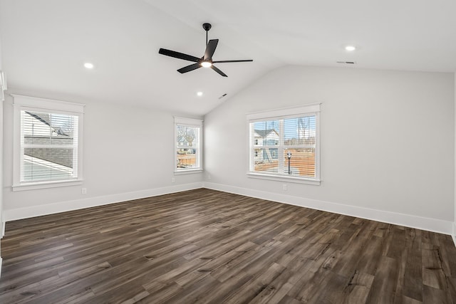 interior space featuring lofted ceiling, dark wood-style flooring, visible vents, and baseboards