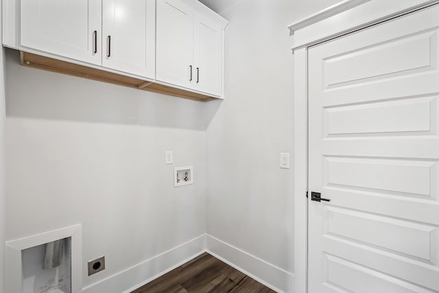 washroom with cabinet space, baseboards, dark wood finished floors, hookup for an electric dryer, and washer hookup