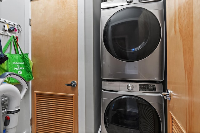 laundry room featuring stacked washing maching and dryer and laundry area