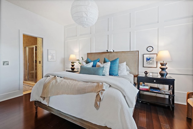 bedroom with a decorative wall and wood finished floors