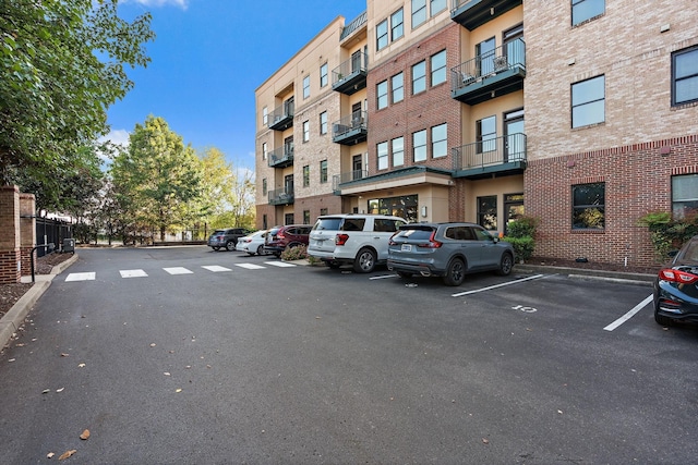 view of building exterior with uncovered parking