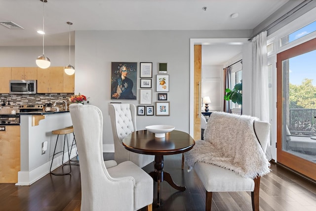 interior space featuring dark wood-style flooring, visible vents, and baseboards