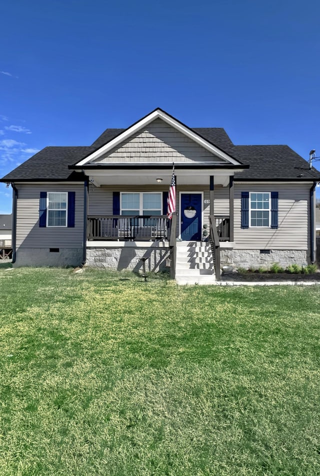 view of front of home featuring a porch, a front yard, crawl space, and a shingled roof