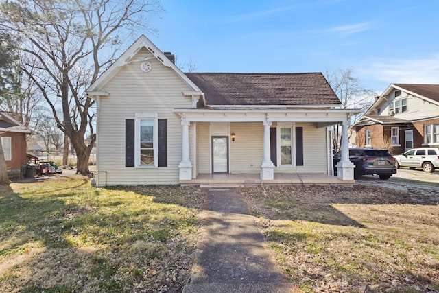 view of front of property featuring a chimney and a porch