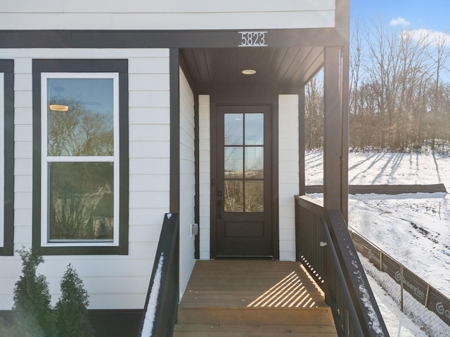 view of snow covered property entrance