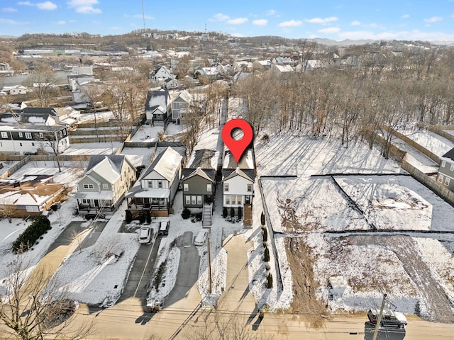 snowy aerial view with a residential view