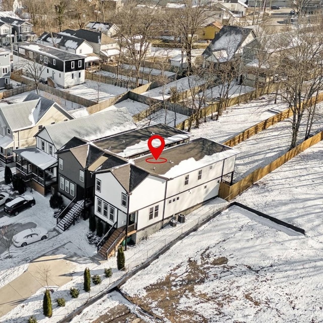 snowy aerial view with a residential view