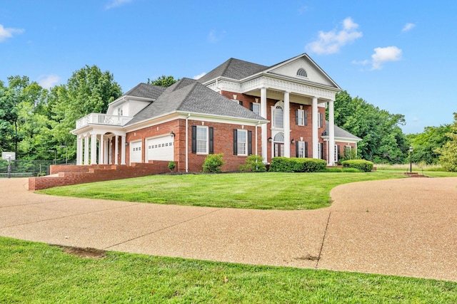 1465 New Columbia Hwy, Lewisburg, TN 37091 - neoclassical home with brick siding, concrete driveway, a front yard, a garage, and a balcony