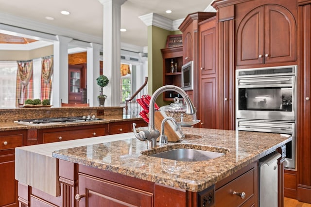 1465 New Columbia Hwy, Lewisburg, TN 37091 - kitchen featuring light stone counters, an island with sink, a sink, appliances with stainless steel finishes, and crown molding